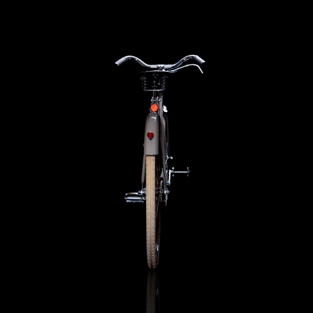 Old refurbished retro bike isolated on black background with reflection view from behindの写真素材