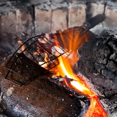 Detail bacon embedded in the grid roasted on fireの写真素材