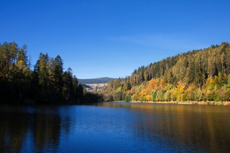 The level of the lake with the reflection of the surrounding landscape autumnの写真素材