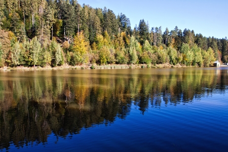 The level of the lake with the reflection of the surrounding landscape autumnの写真素材