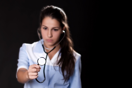 Portrait of woman doctor with blurred face and focus on the stethoscopeの写真素材