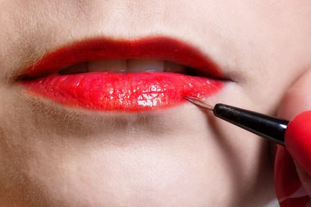 Detail of female lips painted with a brushの写真素材