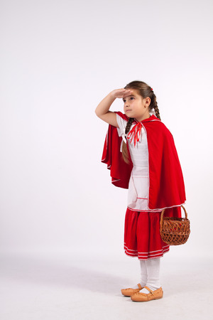 girl in a costume of red cap with a basket in her handの写真素材