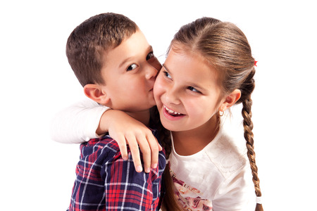 Brother and sister in a hug, smilingの写真素材