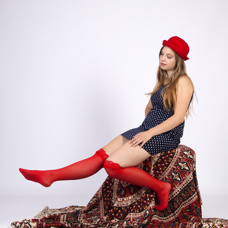 Young woman in red hat in gartersの写真素材