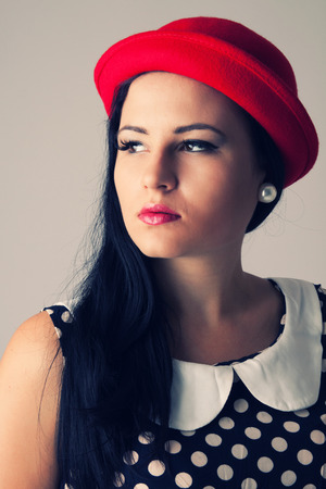 Young woman with red hat, the dress with dotsの写真素材