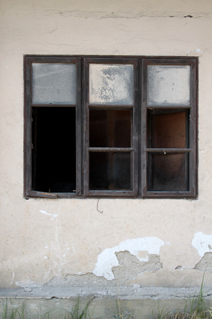 Old shabby wall with old broken wooden windowの写真素材