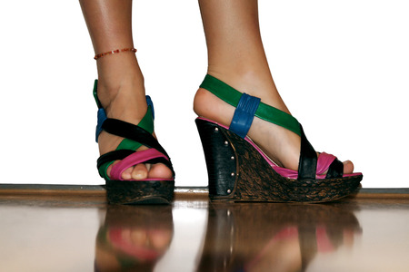 Female legs in colorful high-heeled sandalsの写真素材