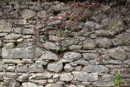 Old shabby wall of large hewn stonesの写真素材