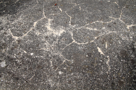 Detail of an old cracked asphalt roadの写真素材