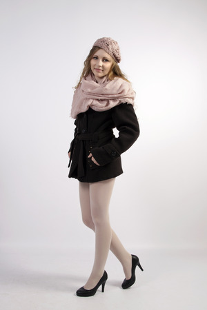 The young long-haired blond woman in French style, with beret and short coatの写真素材