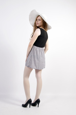 The young long-haired blond woman in French style, with a large hat and short dressの写真素材