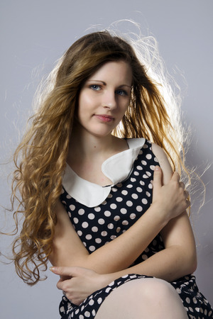 Young long-haired curly blonde woman presented beautiful natural long curly blond hairの写真素材