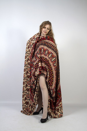 Young long-haired curly blonde woman posing wrapped in a mandalaの写真素材