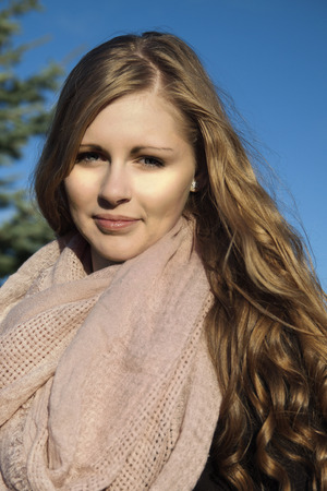 Young long-haired curly blonde woman presented beautiful natural long curly blond hairの写真素材