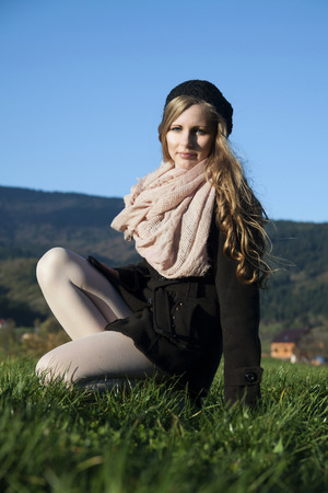 The young long-haired blond woman in French style, with beret and short coatの写真素材