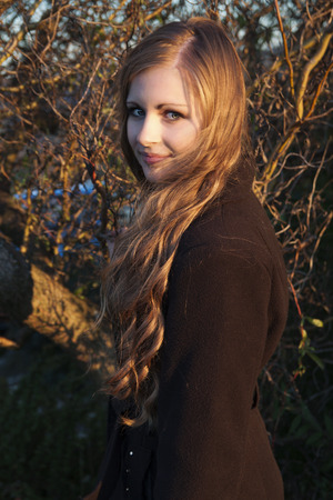 Young long-haired curly blonde woman presented beautiful natural long curly blond hairの写真素材