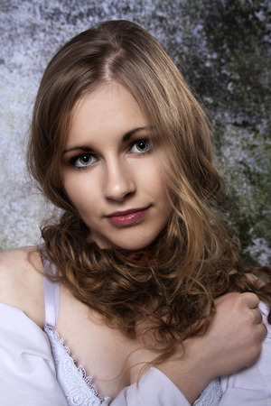 Young long-haired curly blonde woman presented beautiful natural long curly blond hairの写真素材