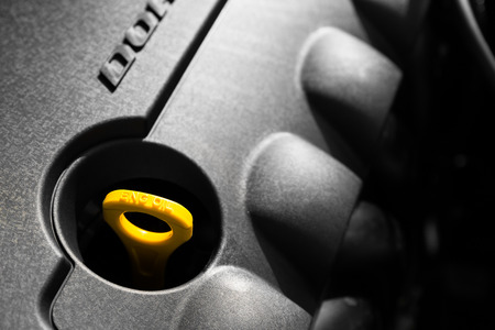 a car engine dipstick, plastic engine casingの写真素材