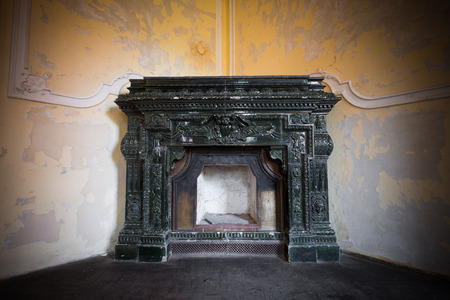 a very old ornate fireplace in an old buildingの写真素材
