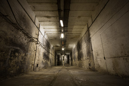 inside an old industrial building, basement with little light