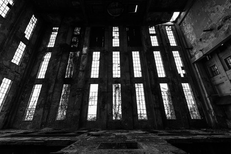 a desolate old industrial building inside, windowsの写真素材