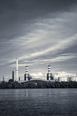 an industrial facility next to a river, sunsetの写真素材