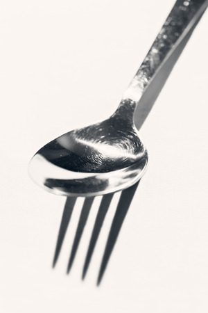 metal spoon fork with a shade, on a white tableclothの写真素材