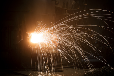furnace operating a foundry, poor lightの写真素材