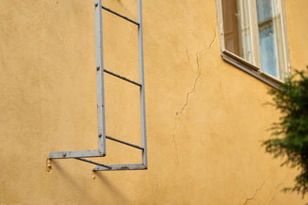 Fire escape on the yellow wall.の写真素材