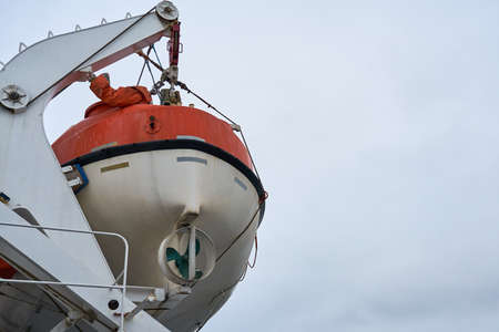 A lifeboat against a cloudy sky. Copy space.の写真素材