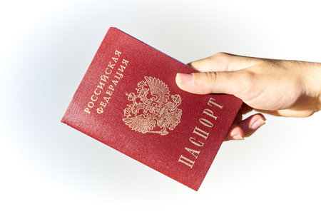 Woman's hand giving Russian passport close up.の写真素材