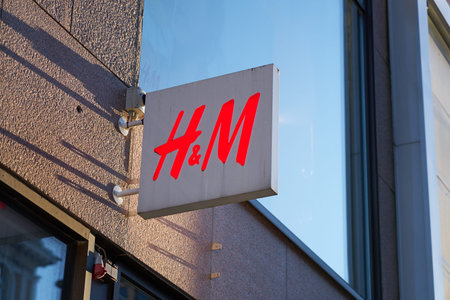 TURKU, FINLAND - 26 FEBRUARY 2021: H and M logo on the front of the building. Clothing-retail...
