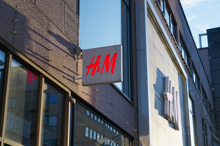 TURKU, FINLAND - 26 FEBRUARY 2021: H and M logo on the front of the building. Clothing-retail...