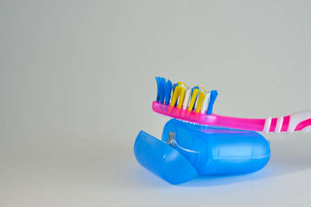 The toothbrush rests on the dental floss on a white background. Medical concept.の写真素材