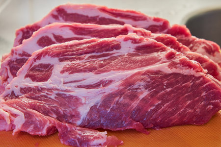 The pork steaks on a cutting board.