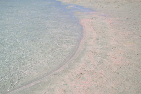 White pink sand and blue water close-up as an abstract background.の写真素材