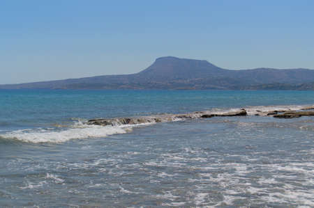 Sea and waves view with mountain in the backgroundの写真素材