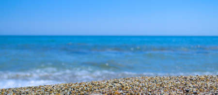 The texture of the sand in the foreground and the blue sea as a blurry background.の写真素材