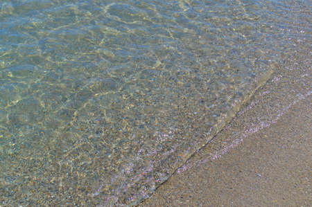Transparent sea wave on the sandy shore.の写真素材