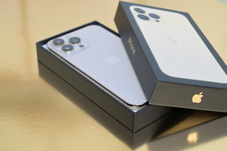 Turku, Finland- 26 September, 2021: New iPhone 13 Pro Max in an open box on a glossy gold surfaceのeditorial素材
