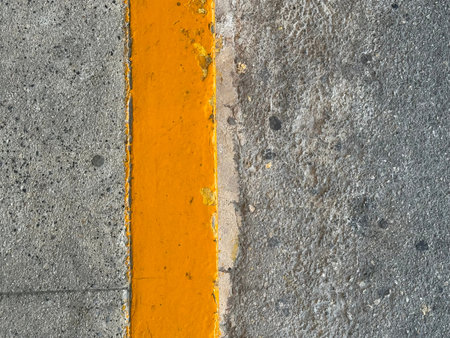 Yellow markings on dry asphalt close-up.