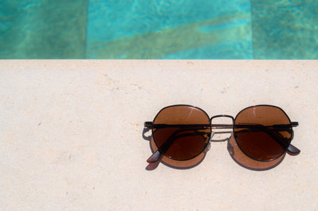 Sunglasses on the edge of the pool. High quality photo