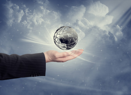 Hand with globe and cloudsの写真素材