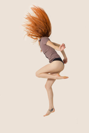  red hair woman jumping の写真素材