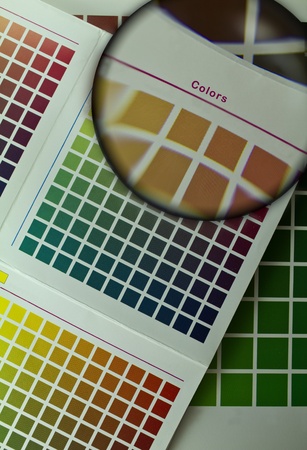Color guide for offset print with a magnifier lens over the tableの写真素材