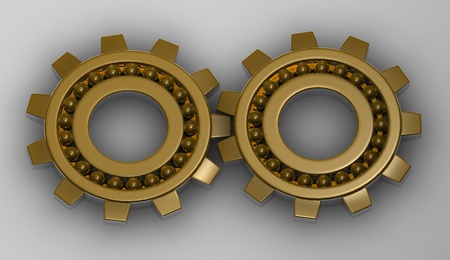 Gold gear steel bearings working together.の写真素材