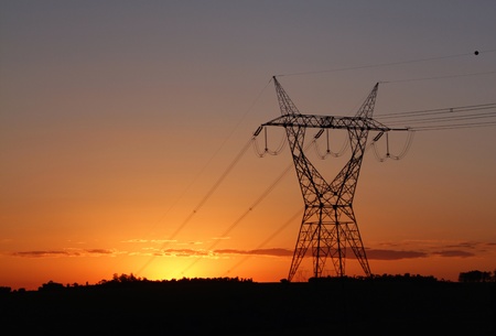 Eletricity tower providing energy distribution over sunsetの写真素材