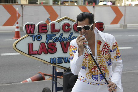 SAO PAULO, BRAZIL - FEBRUARY 08, 2015: An unidentified street musician imitates Elvis Presley dressed with typical vintage rock dress in Paulista Avenue at Sao Paulo Brazil.のeditorial素材