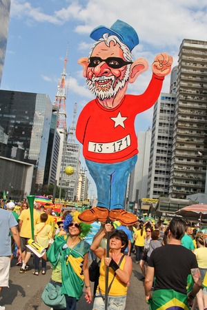 SAO PAULO, BRAZIL August 16 2015: An unidentified group of people with flags and yellow and green clothes in the protest against federal government corruption in Sao Paulo Brazil.のeditorial素材
